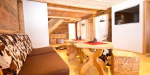 a living room with a table and a couch at Haus Bergfelder in Hirschegg