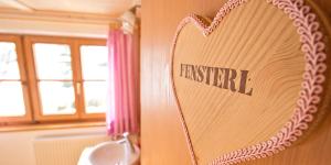 a heart hanging on a wall with the word transfer at Haus Bergfelder in Hirschegg +16 photos