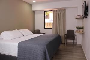Postel nebo postele na pokoji v ubytování Hotel Boutique Plaza