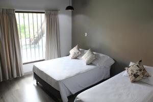 Postel nebo postele na pokoji v ubytování Hotel Boutique Plaza