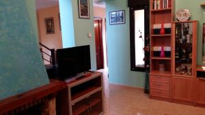 a living room with a flat screen tv and a entertainment center at Chalet "El Bosque" 5 habitaciones in Nueva de Llanes