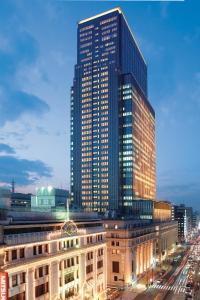 a large building with a clock on the top of it at Mandarin Oriental Tokyo in Tokyo