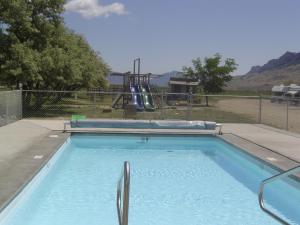 a swimming pool with a slide in a playground at Yellowstone Valley Inn in Wapiti