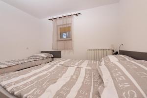 Postel nebo postele na pokoji v ubytování Apartman Sigurnjak