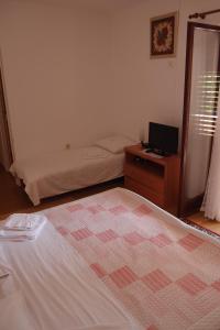 a bedroom with a bed and a desk with a laptop at Villa Lina in Ičići