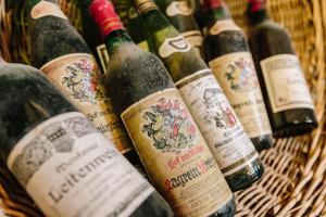 a bunch of wine bottles in a basket at Residence Hof am Keller in Montagna