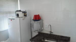 a kitchen with a white refrigerator and a mixer at Lacqua DiROMA V in Caldas Novas +10 photos