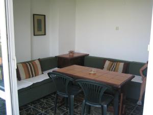 a table and a couch with a table and chairs at Guest House Fanari in Sozopol