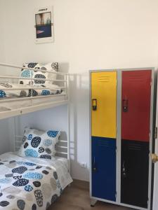 a room with two bunk beds and a bed at Pirata hostel Milfontes in Vila Nova de Milfontes
