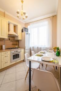 モスクワにあるDream House Smolenskiy Bul'varのキッチン(白いテーブル、椅子、白い冷蔵庫付)