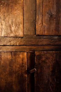 a close up of a wooden door with wood panels at Il Nibbio - Casa dell'artista in Morano Calabro