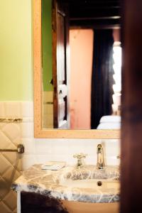 a bathroom with a sink and a mirror at Il Nibbio - Casa dell'artista in Morano Calabro