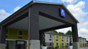 a building with a sign in front of a building at America's Best Value Inn - Memphis Airport in Memphis
