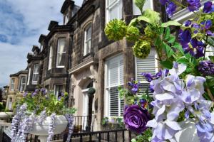 a house with purple and white flowers in front of it at Edinburgh37 in Edinburgh