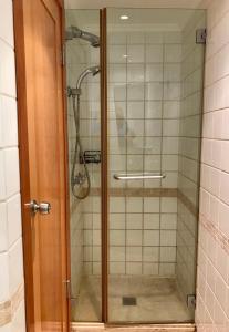 a shower with a glass door in a bathroom at Lagoon suite in Eilat