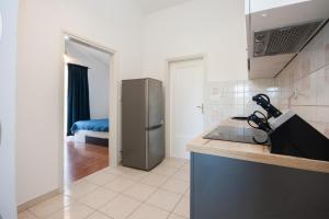 a kitchen with a sink and a refrigerator at Heavenly bay in Šibenik