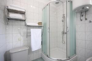 a white bathroom with a shower and a toilet at Heavenly bay in Šibenik +75 photos