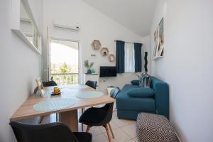 a living room with a table and a blue couch at Heavenly bay in Šibenik