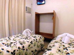 Ein Bett oder Betten in einem Zimmer der Unterkunft Pousada Omnimare
