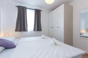 Postel nebo postele na pokoji v ubytování Apartments Kiara