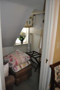 a room with a bed and a window and a chair at Queen Anne Bed and Breakfast in Nevada