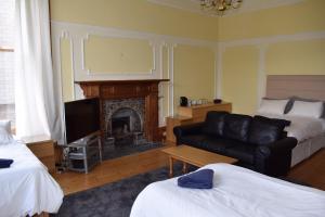 a living room filled with furniture and a fire place at Ardgowan Guest House in Edinburgh