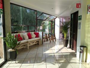 a living room with a couch on a patio at Hotel Boutique Acocalli in San Juan Teotihuacán