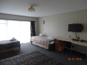 Postel nebo postele na pokoji v ubytování Ambassador Motel