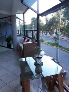 a glass table with a potted plant on top of it at Hotel Boutique Acocalli in San Juan Teotihuacán