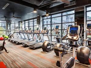 a gym with a row of treadmills and machines at National at Virginia Square in Arlington