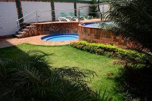 a backyard with a swimming pool and a patio at Gran Hotel Internacional Sanbara in Arauca