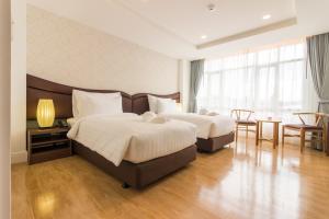 Postel nebo postele na pokoji v ubytování Avada Hotel