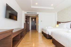 Postel nebo postele na pokoji v ubytování Avada Hotel