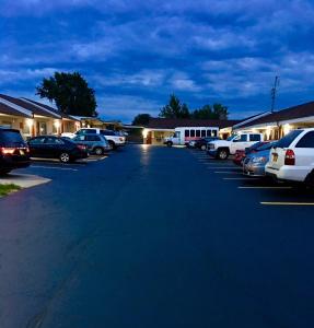 a parking lot with cars parked in front of a building at Budget Inn Williamsville in Williamsville