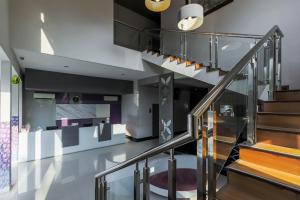 a staircase in a house with black and white at RedDoorz near Goa Sunyaragi in Cirebon