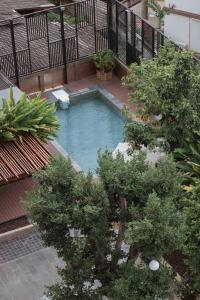 an overhead view of a small swimming pool on a balcony at Sanae' Hotel Chiang Mai in Chiang Mai