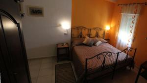 a bedroom with a bed with two pillows on it at B&B Viadelmare in Alghero