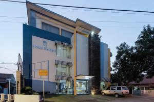 a building with a car parked in front of it at RedDoorz Plus @ Tuparev Cirebon in Cirebon