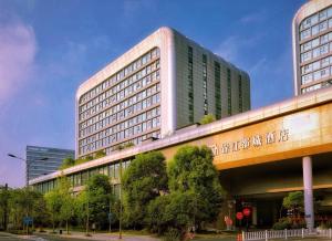 a large building with a bridge in front of it at Metropolo, Hangzhou, East Railway Station in Hangzhou