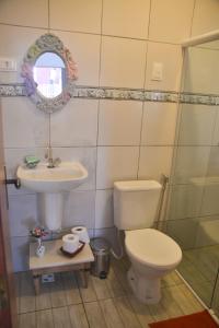 a bathroom with a toilet and a sink at Villa Albardão Serrambi in Porto De Galinhas
