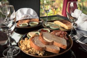 a table with plates of food and glasses of wine at Shangri-Lao Resort in Luang Prabang