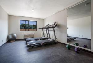 a gym with a treadmill and a mirror in a room at Red Sands Hotel in Torrey