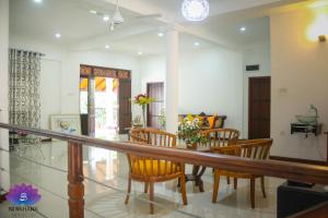 a dining room with a table and chairs at Nivahana Homestay in Kandy
