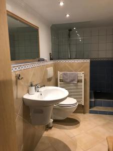 a bathroom with a white toilet and a sink at Schirnaublick in Bünsdorf