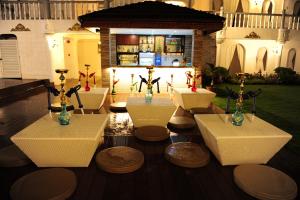 a group of tables with vases on them in front of a house at Boracay Summer Palace Hotel in Boracay