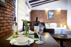 two bottles of wine sitting on a wooden table at Hotel Patan House - Durbar Square in Pātan +43 photos