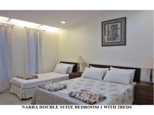 Postel nebo postele na pokoji v ubytování Agreeable Family Baguio Suites