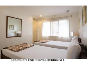 Postel nebo postele na pokoji v ubytování Agreeable Family Baguio Suites