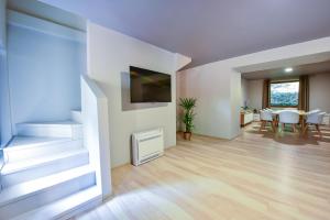 a living room with a table and a tv on a wall at Arsenal Park Transilvania in Orăştie