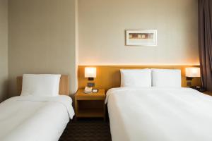 Postel nebo postele na pokoji v ubytování Sotetsu Hotels The Splaisir Seoul Dongdaemun